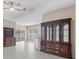 Living room with tile floor, ceiling fan, and built-in hutch at 10952 Arbor View Blvd, Orlando, FL 32825