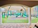 View of a playground through an archway, offering shaded play areas at 10952 Arbor View Blvd, Orlando, FL 32825