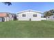 House exterior view from backyard with green grass at 1108 Evangeline Ave, Orlando, FL 32809