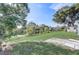 Large backyard with lush grass, mature trees, and a shed at 1108 Evangeline Ave, Orlando, FL 32809