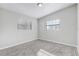 Simple bedroom with grey carpet and two windows at 1108 Evangeline Ave, Orlando, FL 32809
