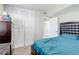Bedroom with teal bedding, built-in closet, and dark brown dresser at 1108 Evangeline Ave, Orlando, FL 32809