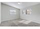 Bright bedroom with neutral carpet and two windows at 1108 Evangeline Ave, Orlando, FL 32809