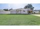 Newly renovated gray house with green lawn at 1108 Evangeline Ave, Orlando, FL 32809