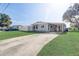 Gray house with a carport and a spacious yard at 1108 Evangeline Ave, Orlando, FL 32809