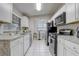 White kitchen with stainless steel appliances and ample counter space at 1108 Evangeline Ave, Orlando, FL 32809