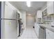 Modern kitchen with stainless steel appliances and white cabinets at 1108 Evangeline Ave, Orlando, FL 32809