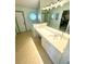 Main bathroom with double vanity, large mirror, and updated fixtures at 1208 Honey Rd, Apopka, FL 32712
