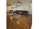 Spacious living room featuring hardwood floors, a large sectional sofa, and ceiling fan at 1208 Honey Rd, Apopka, FL 32712