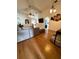 Open living area with hardwood floors, view into kitchen and access to other rooms at 1208 Honey Rd, Apopka, FL 32712