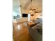 Bright and airy living room with hardwood floors and an open layout, connecting seamlessly to the modern kitchen at 1208 Honey Rd, Apopka, FL 32712