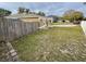 House side yard with wooden fence and grass at 1208 Honey Rd, Apopka, FL 32712