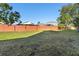 Large backyard with a wooden fence at 13312 Summerton Dr, Orlando, FL 32824
