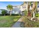 Two-story townhome with landscaped lawn and walkway at 13312 Summerton Dr, Orlando, FL 32824