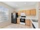 Kitchen features wood cabinets and black appliances at 13312 Summerton Dr, Orlando, FL 32824