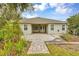 Home with backyard patio, landscaping, and walkway at 13607 Zori Ln, Windermere, FL 34786