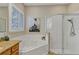 Spa-like bathroom with a corner soaking tub, shower, and granite vanity at 13607 Zori Ln, Windermere, FL 34786