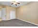 Bedroom with neutral walls, carpeting, double door closet and ceiling fan at 13607 Zori Ln, Windermere, FL 34786