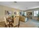 Open concept dining room with seating for six and adjacent living room at 13607 Zori Ln, Windermere, FL 34786