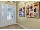 Bright and airy entryway with a decorative door and tasteful wall art at 13607 Zori Ln, Windermere, FL 34786