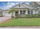 Beautiful one-story home with a landscaped lawn, brick driveway, and a charming front porch at 13607 Zori Ln, Windermere, FL 34786