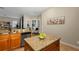 Kitchen boasts granite island, wood cabinets, and views into adjacent living space at 13607 Zori Ln, Windermere, FL 34786