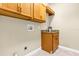 Laundry room with wooden cabinets and granite countertop at 13607 Zori Ln, Windermere, FL 34786
