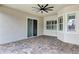 Covered patio with tile flooring, ceiling fan and sliding glass doors at 13607 Zori Ln, Windermere, FL 34786
