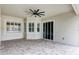 Covered patio with tile flooring, ceiling fan and sliding glass doors at 13607 Zori Ln, Windermere, FL 34786