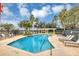 Community pool with lounge chairs and a pergola at 13607 Zori Ln, Windermere, FL 34786