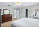 Bright bedroom with a dresser, a bed, and sliding doors leading to a patio at 142 Santana Pl, Davenport, FL 33897