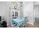 Bright dining area with four chairs and a light blue tablecloth at 142 Santana Pl, Davenport, FL 33897