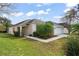 One-story house with attached garage, landscaping, and walkway at 142 Santana Pl, Davenport, FL 33897