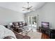 Living room with brown couches, hardwood floors, and sliding glass doors leading to the pool at 142 Santana Pl, Davenport, FL 33897