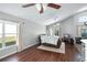 Spacious living room with hardwood floors, large windows, and a view of the backyard at 142 Santana Pl, Davenport, FL 33897