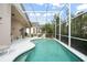 Enclosed pool with patio, steps, and adjacent house at 142 Santana Pl, Davenport, FL 33897