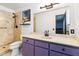 Bathroom includes a shower, vanity with purple cabinets, and a toilet at 1429 Royal Palm Dr, Edgewater, FL 32132