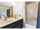 Bathroom with double vanity, bathtub, and updated fixtures at 1429 Royal Palm Dr, Edgewater, FL 32132