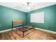 Spacious bedroom with wood flooring, ceiling fan, and dark green walls at 1429 Royal Palm Dr, Edgewater, FL 32132