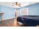 Bright bedroom featuring wood floors and a ceiling fan at 1429 Royal Palm Dr, Edgewater, FL 32132