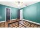 Bedroom featuring dark green walls, wood flooring, and two closets at 1429 Royal Palm Dr, Edgewater, FL 32132