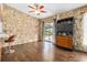 Casual dining area adjacent to kitchen, featuring wood floors and stone accent wall at 1429 Royal Palm Dr, Edgewater, FL 32132