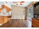 Bright dining area with wood floors, stone wall, and built-in hutch at 1429 Royal Palm Dr, Edgewater, FL 32132