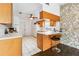 Efficient kitchen with light wood cabinets, breakfast bar and tiled floor at 1429 Royal Palm Dr, Edgewater, FL 32132