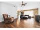 Open living area with sectional sofa, hardwood floors, and stone accent wall at 1429 Royal Palm Dr, Edgewater, FL 32132