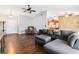 Spacious living room with hardwood floors, sectional sofa, and ceiling fan at 1429 Royal Palm Dr, Edgewater, FL 32132