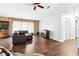 Spacious living room featuring a sectional sofa, wood floors, and a stone accent wall at 1429 Royal Palm Dr, Edgewater, FL 32132