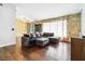 Bright living room with a comfortable sectional sofa and stone feature wall at 1429 Royal Palm Dr, Edgewater, FL 32132