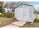 White shed with double doors in the backyard at 1429 Royal Palm Dr, Edgewater, FL 32132