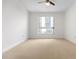 Well-lit bedroom with large window and carpet flooring at 241 Riverside Drive # 409, Daytona Beach, FL 32117